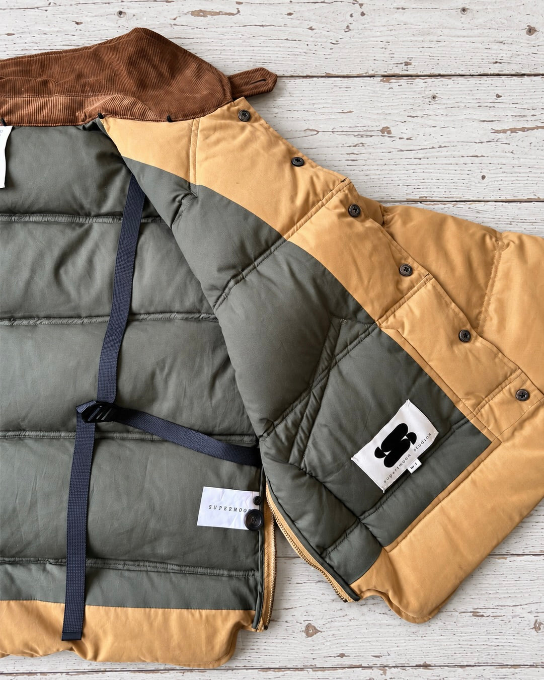 Supermoon Hunting Down Jacket with 90/10 duck down, product image 8. showing close up of internal contrast lining, open side zips and internal shoulder straps.