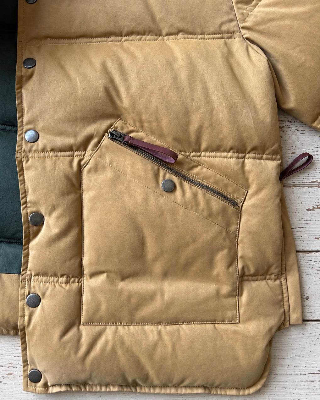 Supermoon Hunting Down Jacket with 90/10 duck down, product image 7. Showing close up of double pocket and leather puller zipper .