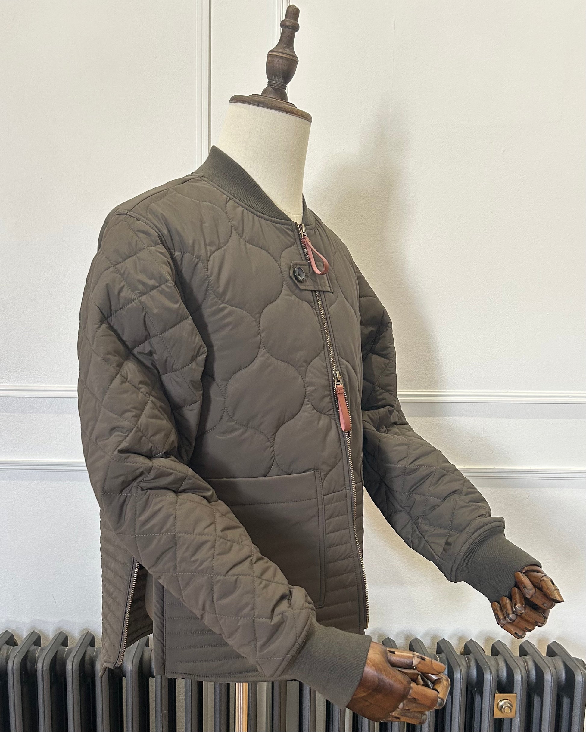 Supermoon Field Liner quilted nylon jacket, product image 4. Showing 3/4 view with side zippers open 
