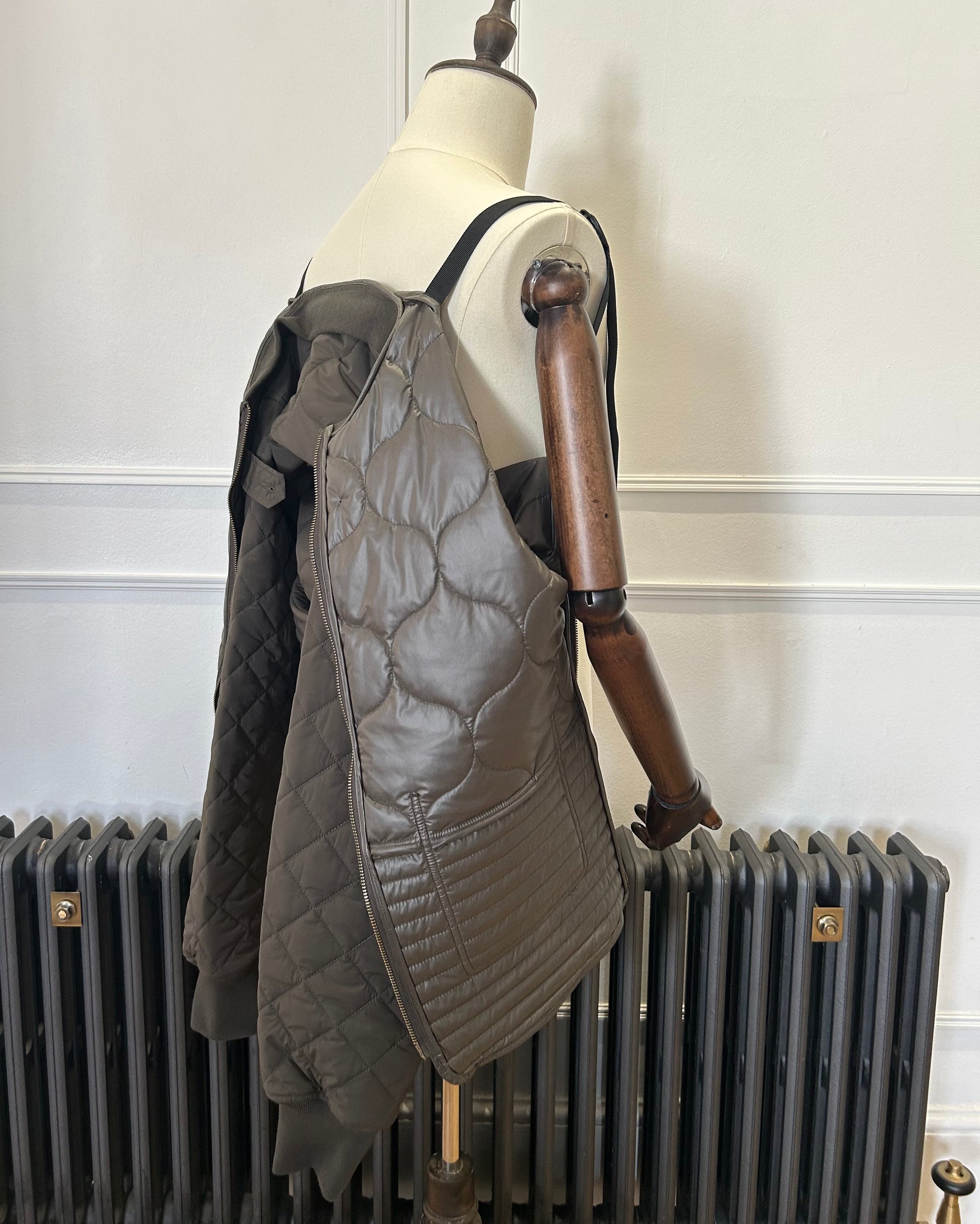 Supermoon Field Liner quilted nylon jacket, product image 5. Showing jacket being worn with the shoulder straps 