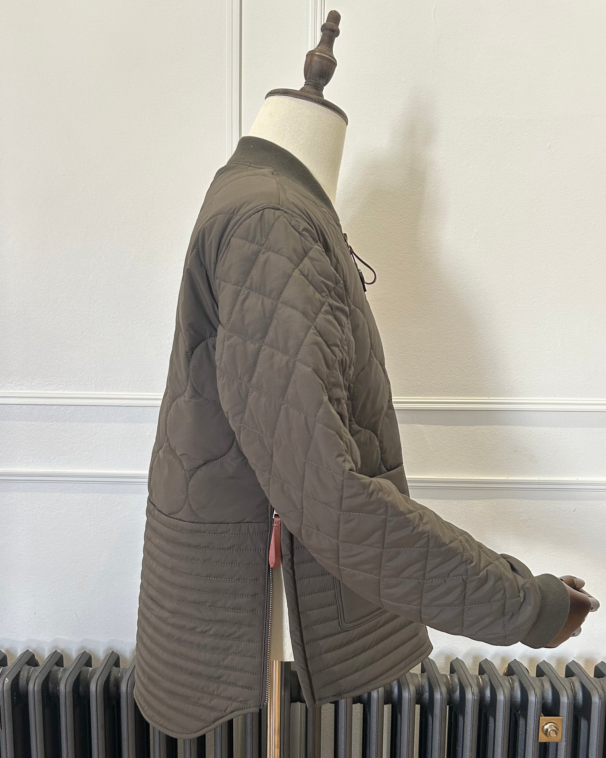 Supermoon Field Liner quilted nylon jacket, product image 3. Showing side view with side zips open 